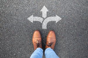 Professional considering whether they are in the right career while standing at a crossroads.
