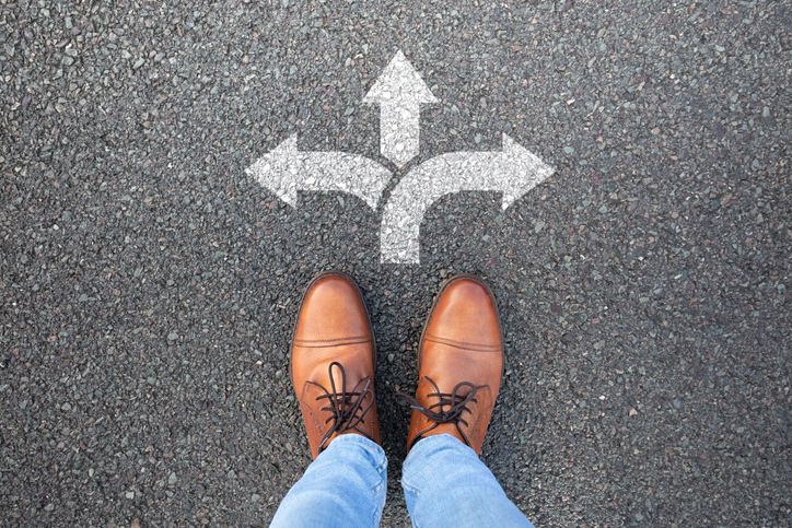 Professional considering whether they are in the right career while standing at a crossroads.
